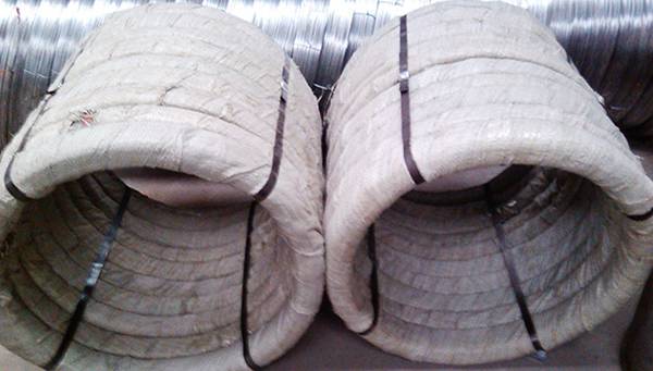 Two bundles of oval wires in plastic film and woven bag package.